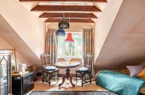 a room with a table and chairs and a window at The Wood Wing Suite at Bellspool in Peebles