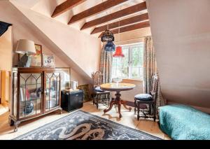 a room with a table and chairs and a window at The Wood Wing Suite at Bellspool in Peebles