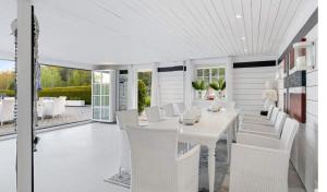 a dining room with a white table and white chairs at Spacious villa with heated pool and stunning view in Tokenes