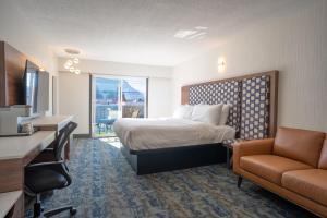 a hotel room with a bed and a couch at Inn The Mountains, an Ascend Collection Hotel in Hope