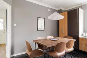 a dining room with a wooden table and chairs at Chic 2-Bedroom apartment on Lidingö in Lidingö