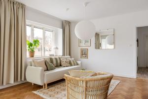 a living room with a couch and a window at Chic 2-Bedroom apartment on Lidingö in Lidingö
