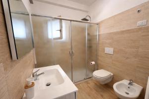 a bathroom with a shower and a sink and a toilet at La Casa al mare Torre San Giovanni in Torre San Giovanni Ugento