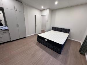 a bedroom with a bed in the middle of a room at Reddy Homes in Lautoka