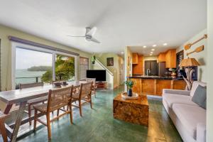 a kitchen and living room with a table and chairs at Hale Kepuhi in Hanalei
