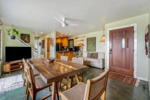 a living room with a wooden table and chairs at Hale Kepuhi in Hanalei +23 photos