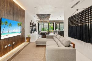 a living room with a couch and a table at Piedras Luxe by Prestigia - Villa in Tulum