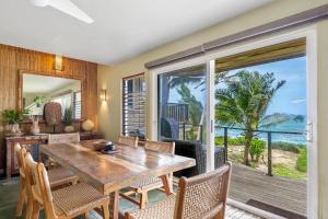 a dining room with a table and a view of the ocean at Hale Kepuhi in Hanalei