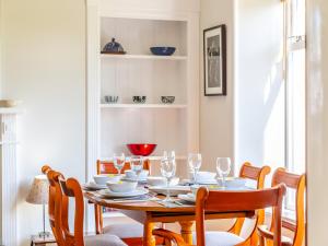 a dining room with a wooden table and chairs at The Laurels in Nairn