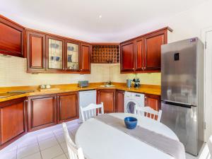 a kitchen with a white table and a refrigerator at The Laurels in Nairn +26 photos