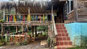 a building with a deck with tables and chairs at Casa Aurea in Medellín