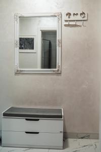 a bathroom with a mirror and a white dresser at Apartman Centar in Doboj
