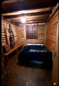 a bedroom with a bed in a log cabin at Casa Aurea in Medellín