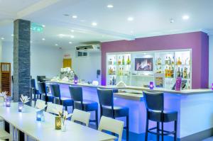 a restaurant with tables and chairs and a bar at Q-Inn Boutique Hotel in Paramaribo