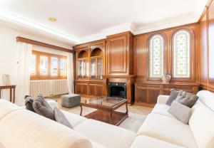 a living room with a white couch and a fireplace at Can Maro in Santa Margalida