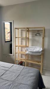 a bedroom with a bunk bed next to a window at Costa Suite Enseada in Guarujá +19 photos