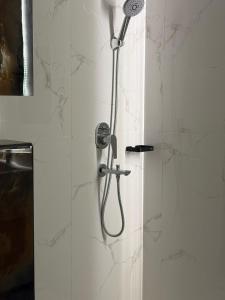 a shower with a shower head in a bathroom at Pure Stay House in Taif +26 photos