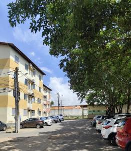 a parking lot with cars parked next to a building at Haurea House in São Luís