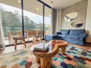 a living room with a couch and a table at Upscale 2BR Countryside Suite | Stylish & Modern in El Retiro