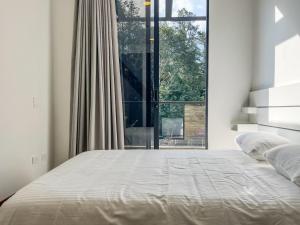 a bedroom with a bed with a large window at Upscale 2BR Countryside Suite | Stylish & Modern in El Retiro