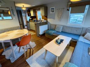 a living room with a couch and a table at Jazmine's Place in Ayr