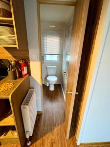 a small bathroom with a toilet and a sink at Jazmine's Place in Ayr +25 photos