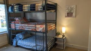 two bunk beds in a room with a lamp at Central Mountain Retreat - Sleeps 7! in Logan