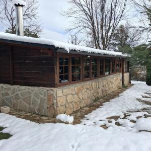 a building with snow on top of it at El Molino de Candelario in Candelario