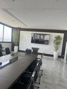 a conference room with a long table and chairs at Hôtel NGOR ALMADIES 4 étoiles in Dakar