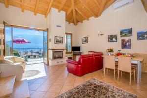 a living room with a red couch and a table at Tremezzo Ulivi Apt.7 in Tremezzo