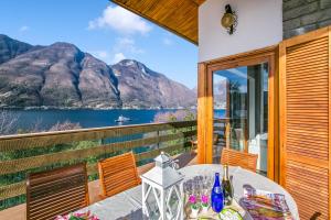 a balcony with a table and a view of the water at Villa Marilyn in Nesso