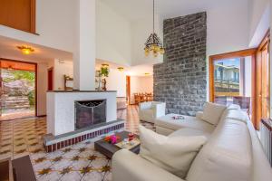 a living room with a couch and a fireplace at Villa Marilyn in Nesso