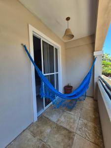 a hammock on the balcony of a house at Cumbuco Residence #203 in Caucaia