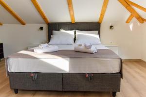 a bedroom with a large bed with towels on it at Carmen Old Town Apartments in Sarajevo