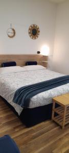 a bedroom with a bed and a table and a mirror at Cristel Malpensa apartment in Cardano al Campo