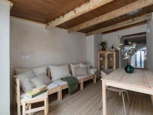 a living room with a couch and a table at Calderona Tiny house in Segorbe