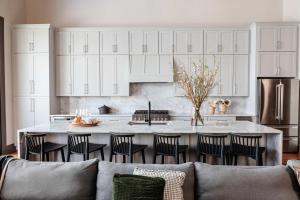 a kitchen with a couch and a large kitchen island at Expansive 7 Bedroom Home Heated Pool & Spa in New Orleans