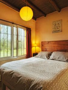 a bedroom with a large bed and two windows at Finca La Penúltima-Posada in San Rafael +72 photos