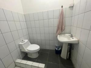 a white bathroom with a toilet and a sink at Casa Che in Valparaíso +29 photos