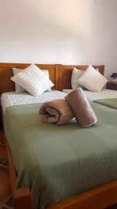 a towel laying on top of two beds at Villa 7 - Vale do Lobo in Almancil +11 photos