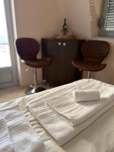 a close up of a bed with two stools at M Premium Apartments in Paraćin +5 photos