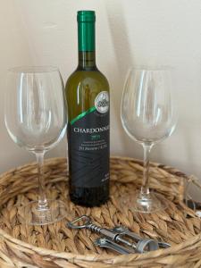a bottle of wine sitting next to two wine glasses at M Premium Apartments in Paraćin