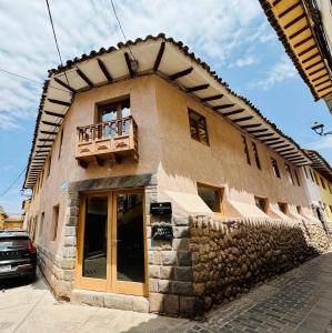a building with a balcony on top of it at Hm Montes Central in Cusco