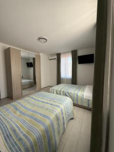 a hotel room with two beds and a mirror at La Locanda del Giardino in Lentate sul Seveso