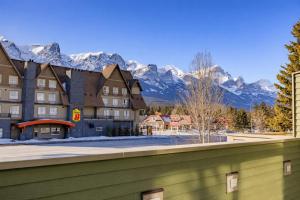 a view of a hotel with mountains in the background at Dolomites #203 - LEED Gold Certified in Canmore