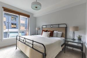a bedroom with a large bed and a window at Inspired Elegance at Tamarack Lodge in Canmore
