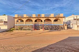 a building with balconies on top of it on a dirt road at Spacious Oceanview Home Casa de Los Amigos in Puerto Peñasco