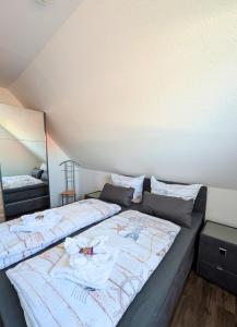 a bedroom with a bed with flowers on it at Haus Ausreißer 2 - Heimathafen in Bensersiel