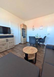 a living room with a couch and a table at Haus Ausreißer 2 - Heimathafen in Bensersiel