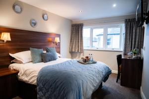 a bedroom with a large bed with a wooden headboard at Foundry 34 in Penrith